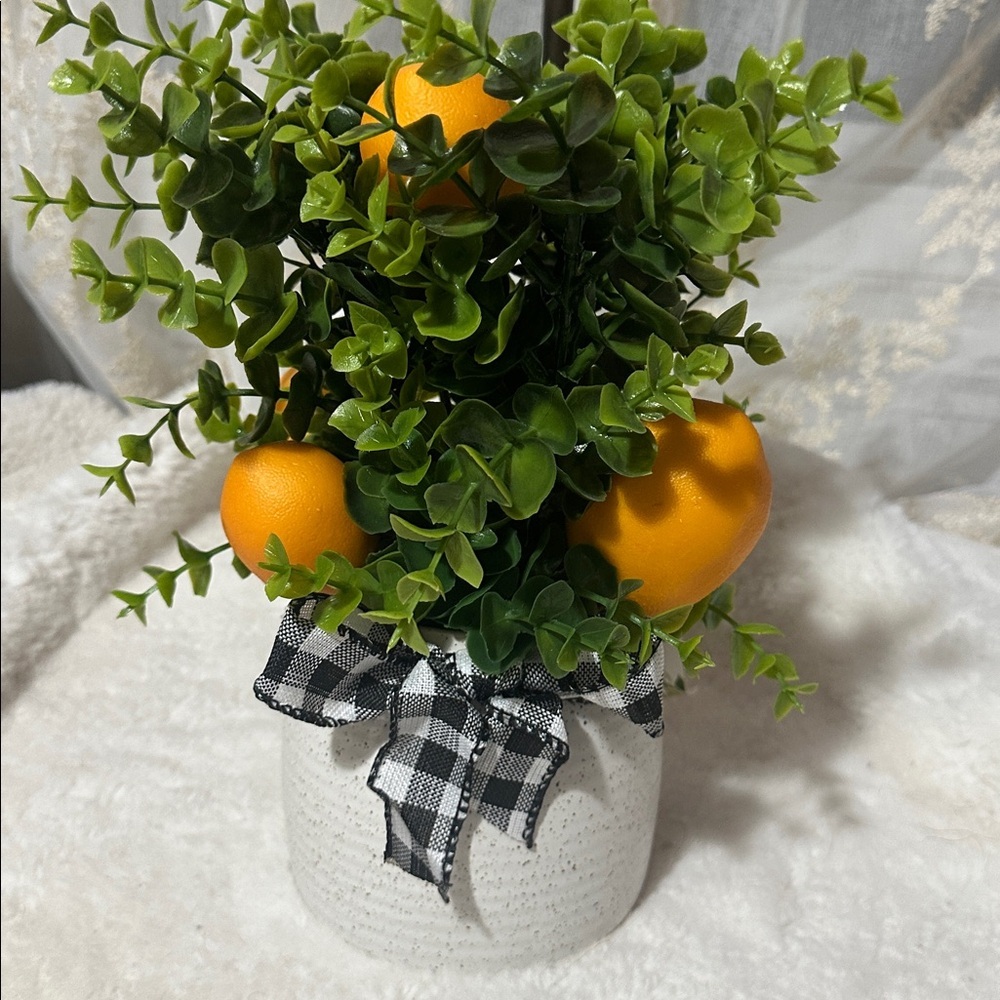 Orange fruit greenery in ceramic pot